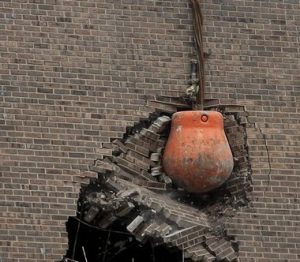 A wrecking ball hitting a wall