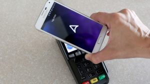 A mobile phone making an NFC payment