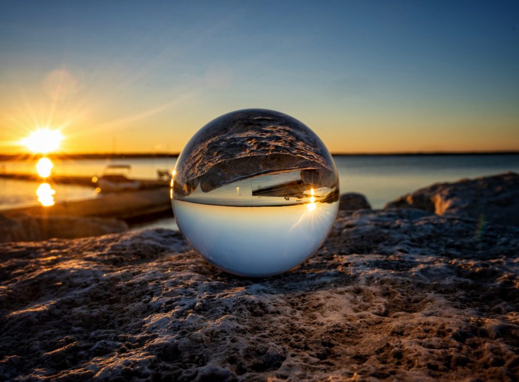 Crystal ball on the rocks at sunset