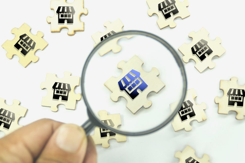 magnifying glass looking for a merchant or business. looking for a store