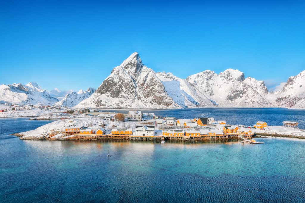 Fabulous winter view of Sakrisoy village and snowy mountaines on background.